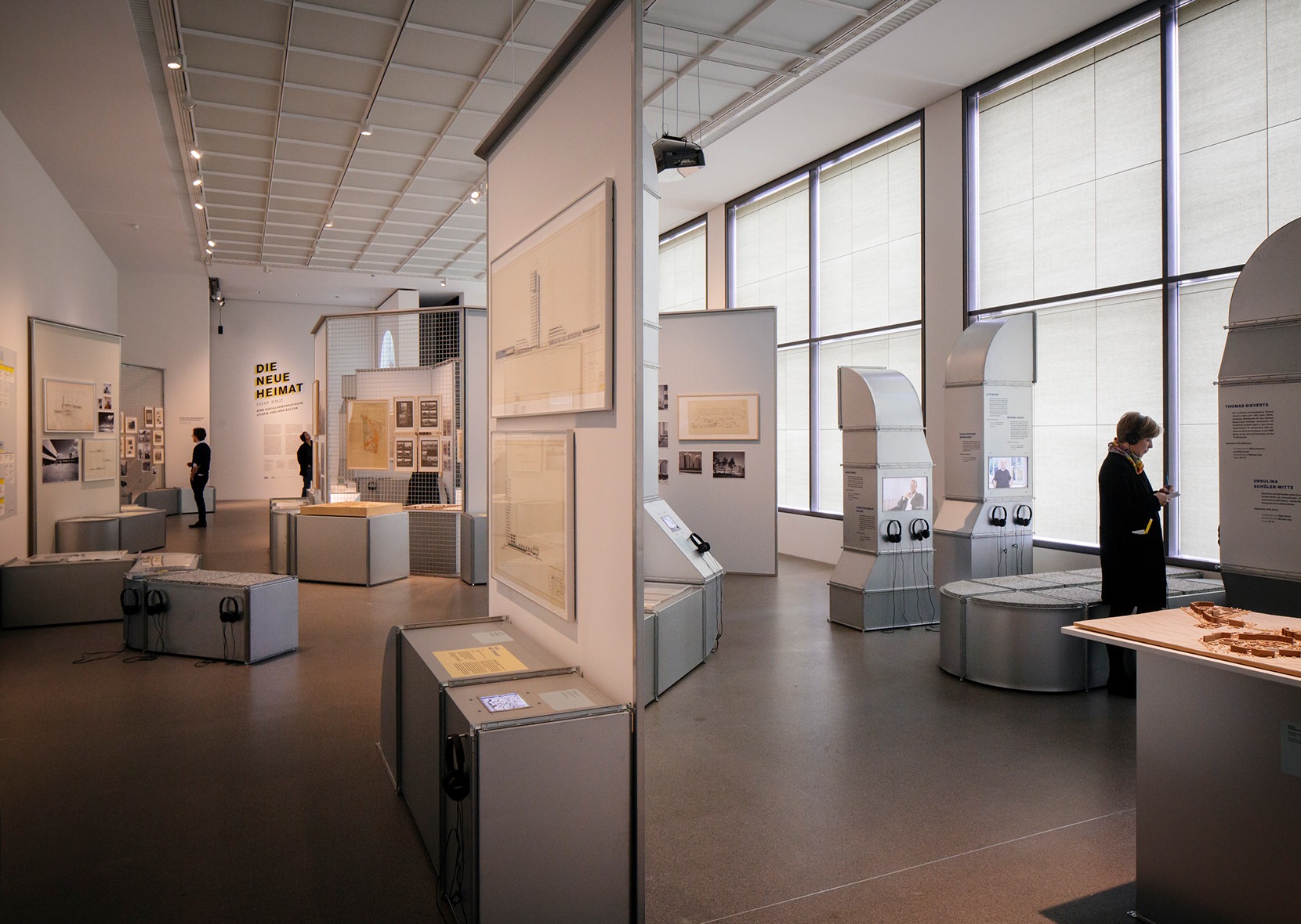 three persons in exhibition room