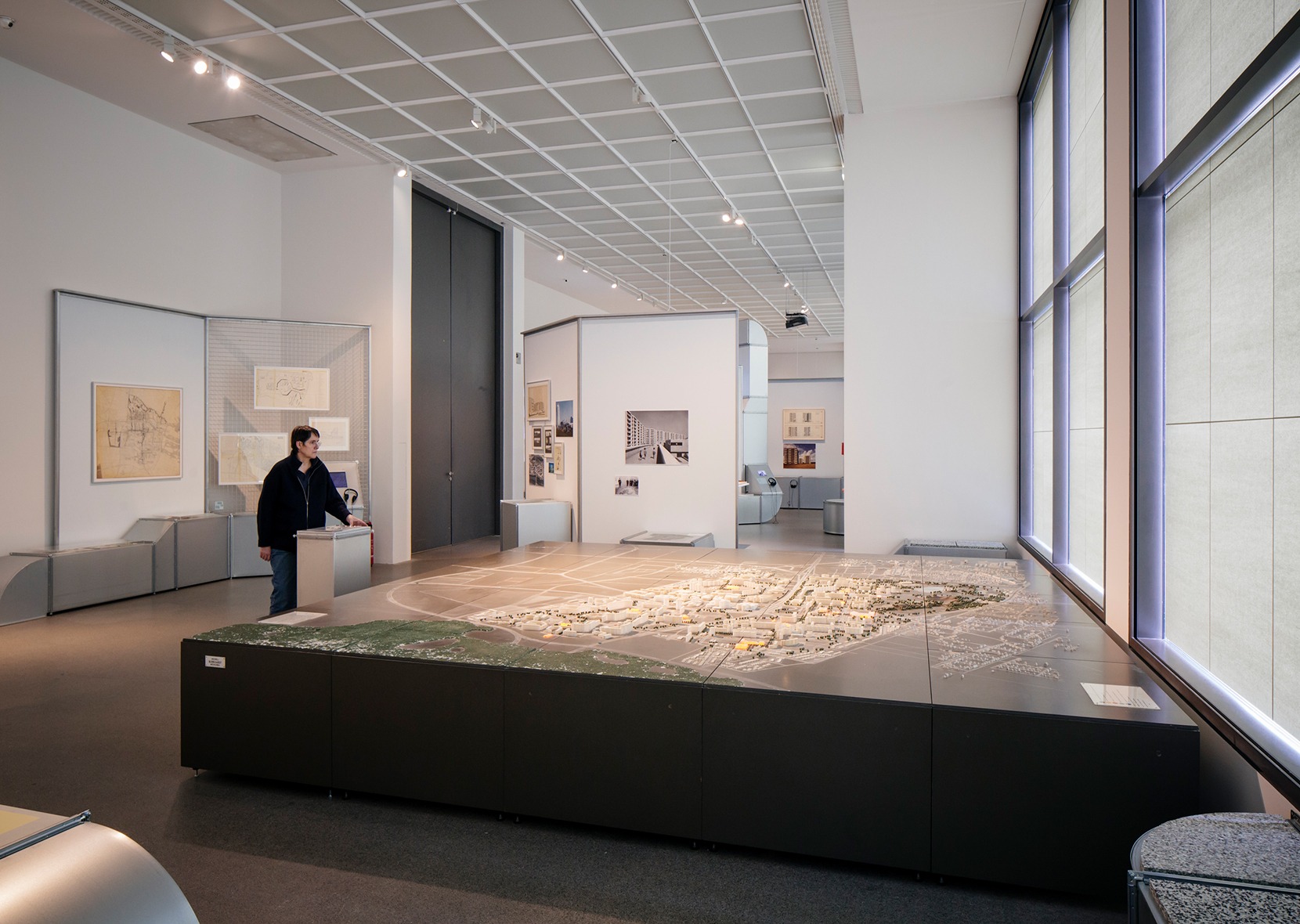 person looking at big architectural model