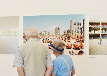 two people looking at photo on the wall
