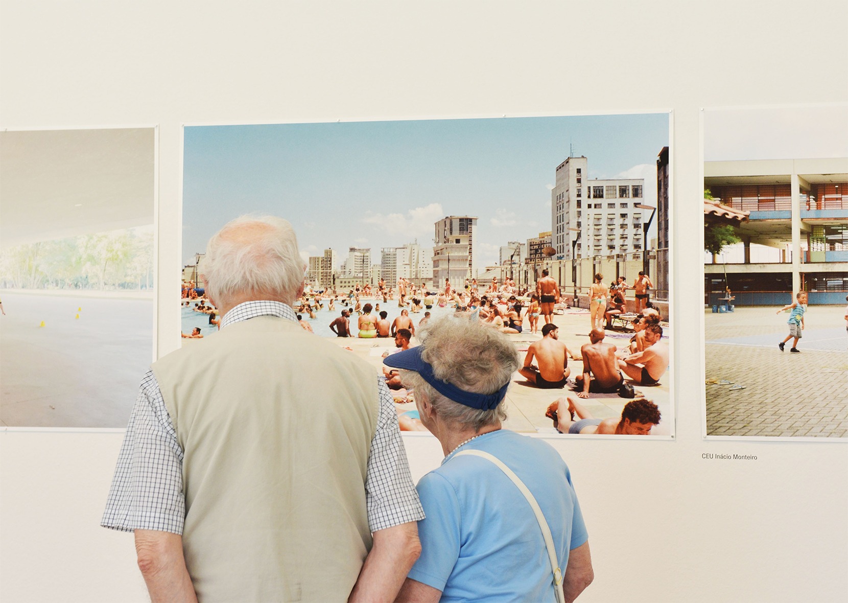 two people looking at photo on the wall